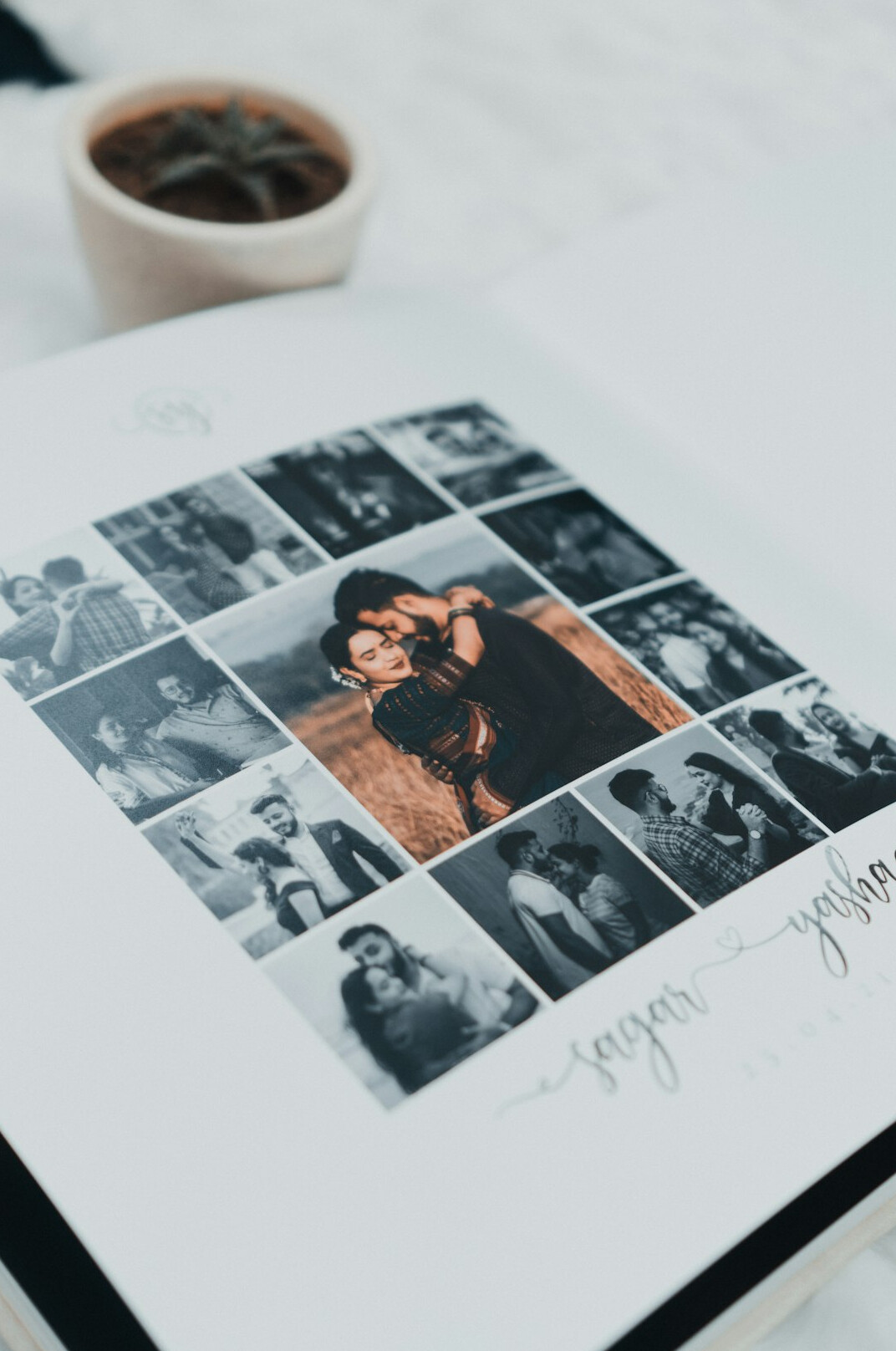 Vintage black and white photographs spread on a table with a notebook