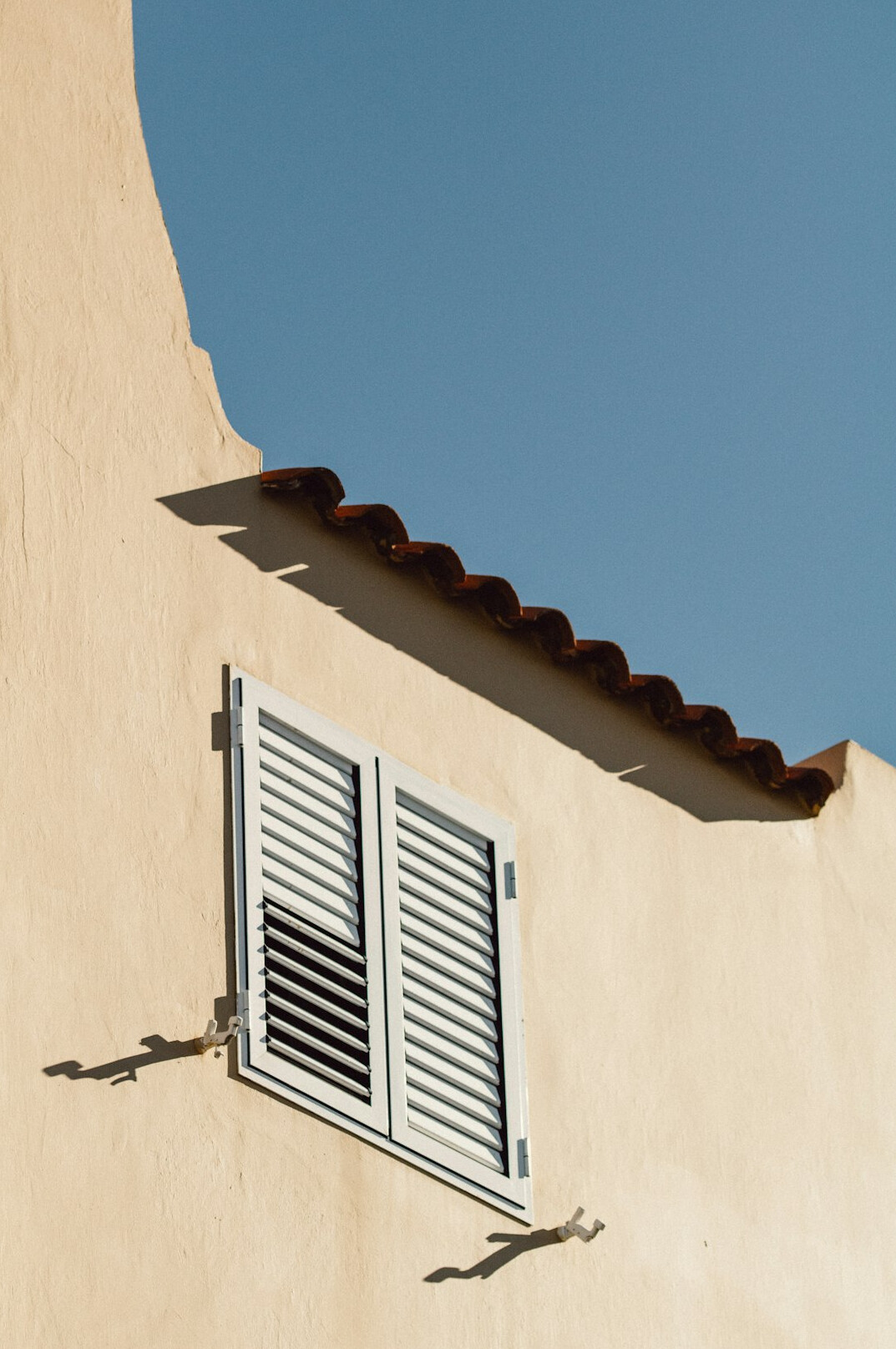 Faded colonial facade with wooden shutters in Colonia del Sacramento